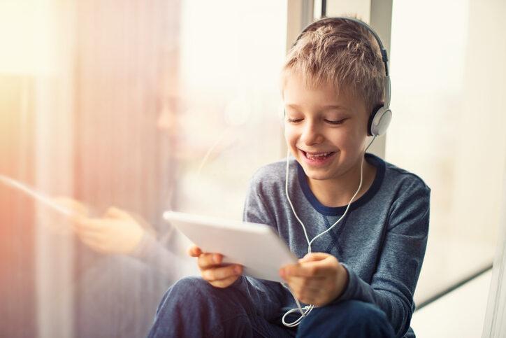 happy-little-boy-using-tablet-with-headphones